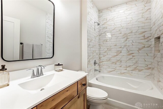 full bathroom with tiled shower / bath combo, toilet, and vanity