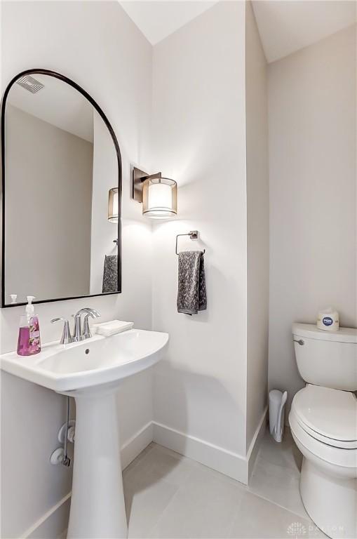 bathroom featuring tile patterned floors and toilet