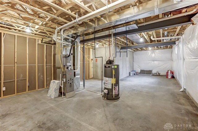 basement featuring gas water heater and heating unit