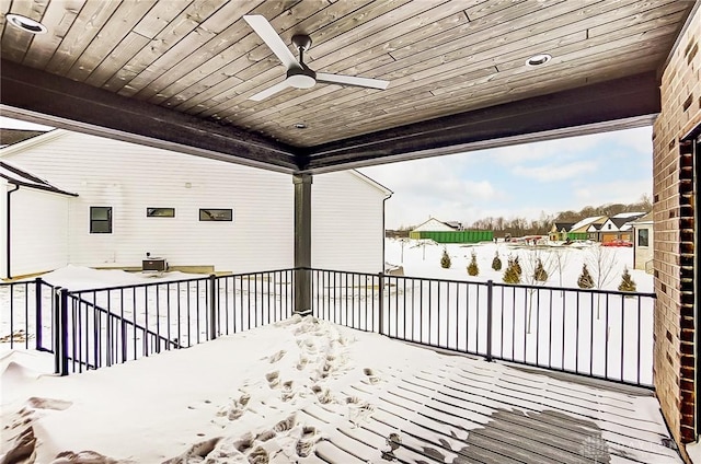 snow covered deck with central AC unit and ceiling fan