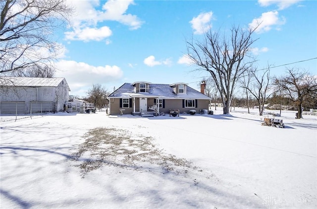 snow covered property featuring a chimney