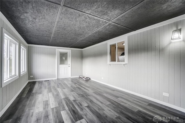 empty room featuring baseboards and wood finished floors