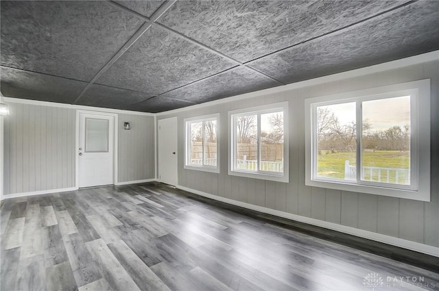 empty room featuring baseboards and wood finished floors