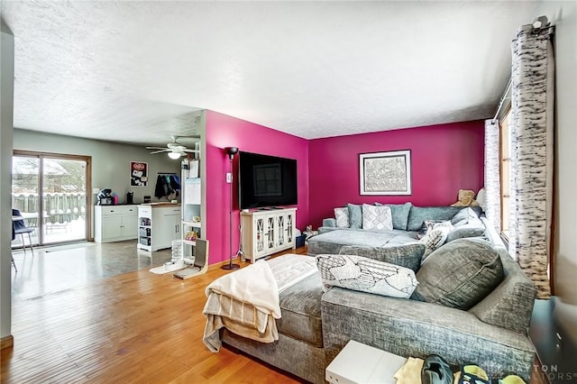 living room featuring hardwood / wood-style floors and ceiling fan