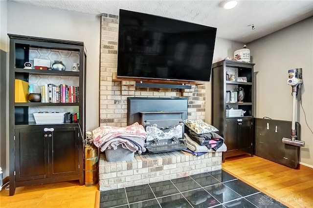 living room with light wood-type flooring and a fireplace