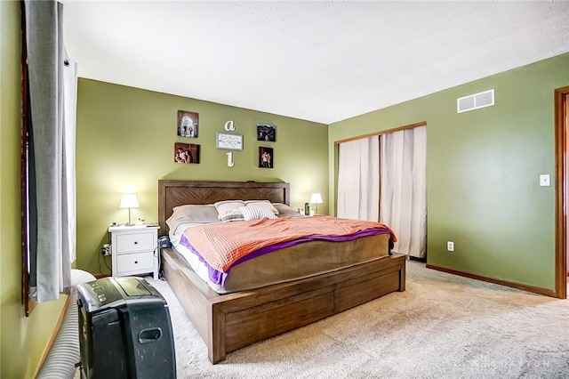 bedroom with light colored carpet