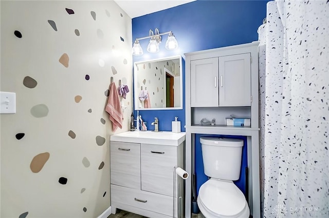 bathroom featuring a shower with shower curtain, vanity, and toilet