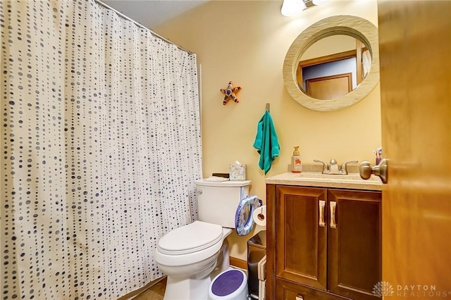 bathroom with vanity, toilet, and walk in shower