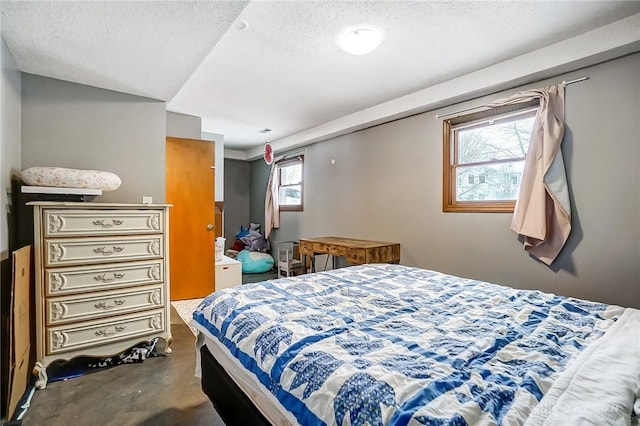 bedroom featuring a textured ceiling and concrete floors