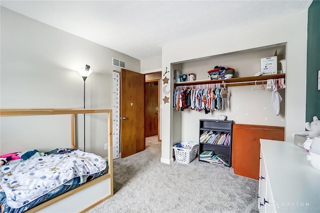 carpeted bedroom with a closet