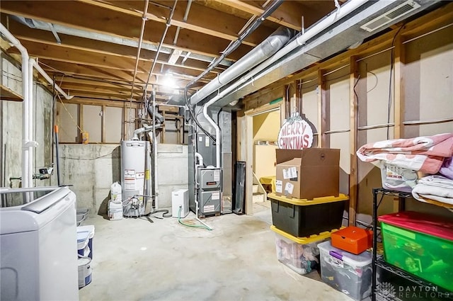 basement with heating unit, washer / dryer, and water heater