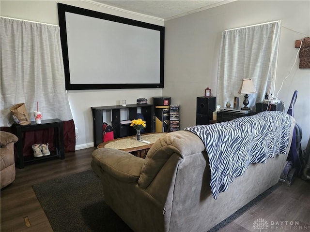 cinema room with dark hardwood / wood-style flooring and ornamental molding