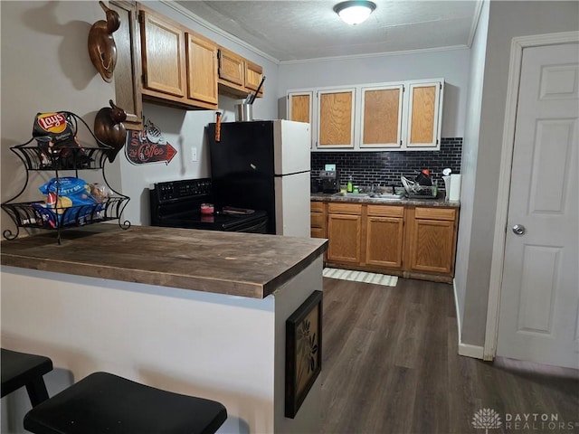 kitchen with butcher block counters, black electric range, ornamental molding, and white refrigerator