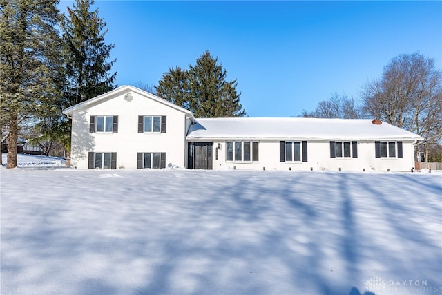 view of snow covered back of property