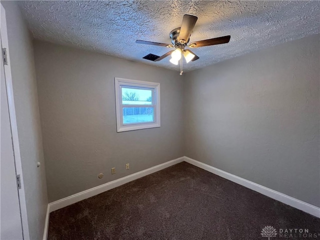 carpeted empty room with a textured ceiling and ceiling fan