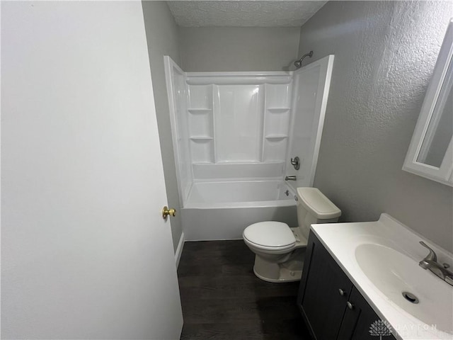 full bathroom featuring wood-type flooring, a textured ceiling, toilet, shower / tub combination, and vanity