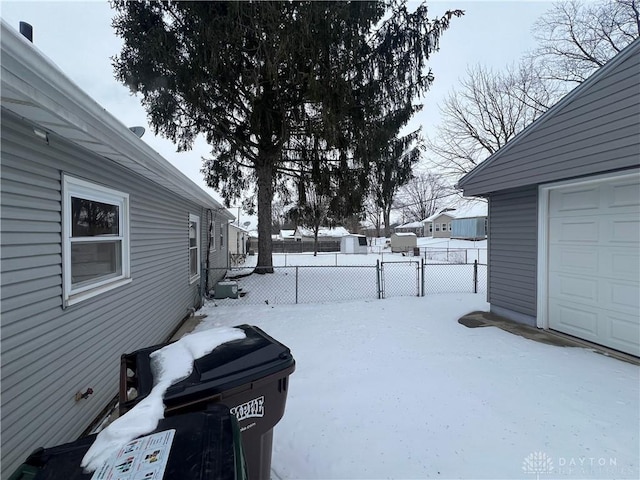 yard covered in snow with a garage