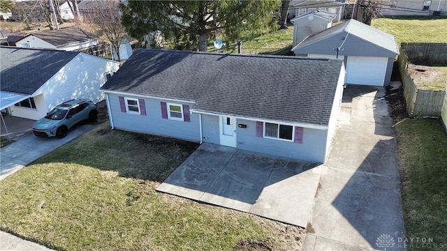 ranch-style house with a garage, a shingled roof, an outdoor structure, fence, and a front yard