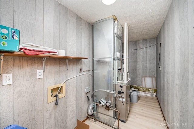 bathroom with a textured ceiling and wood finished floors