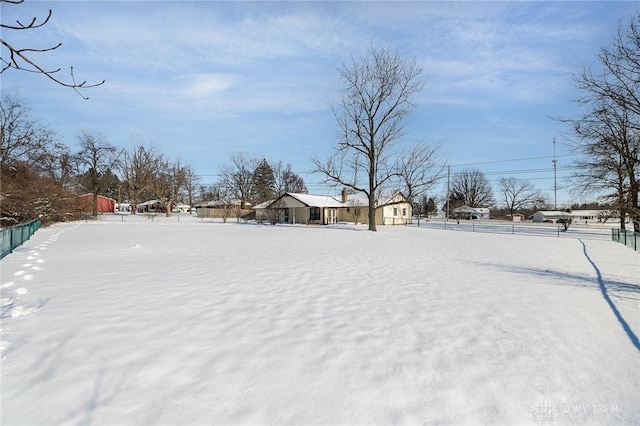 yard covered in snow with fence