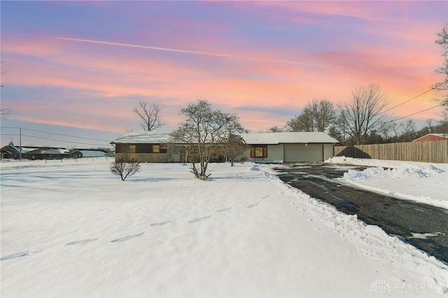 view of front of house featuring a garage and an outbuilding