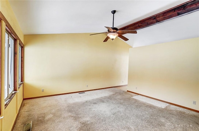 carpeted empty room with lofted ceiling with beams and ceiling fan