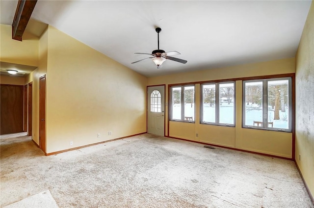 empty room featuring lofted ceiling with beams, light colored carpet, and ceiling fan