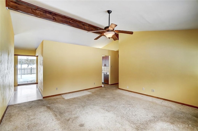 empty room featuring light carpet, vaulted ceiling with beams, and ceiling fan