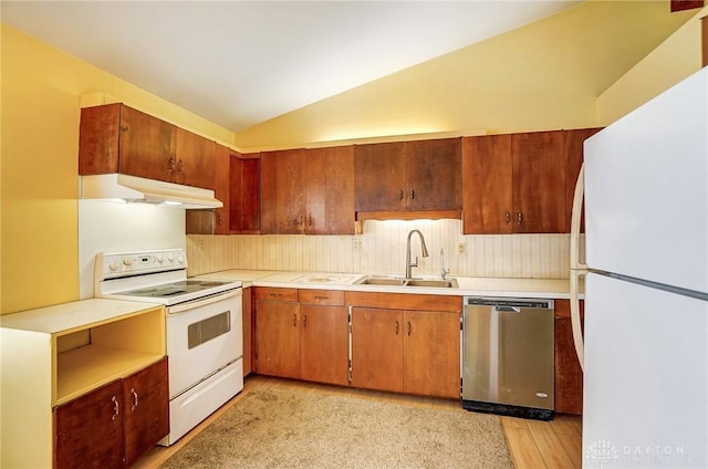 kitchen with lofted ceiling, sink, and white appliances