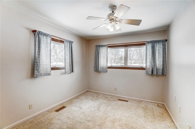 carpeted spare room with ceiling fan