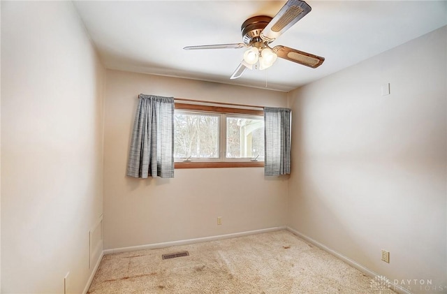 carpeted empty room featuring ceiling fan