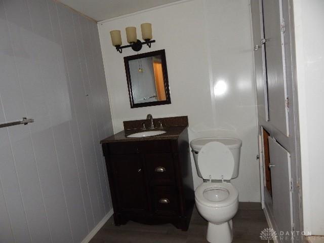 bathroom featuring toilet and vanity
