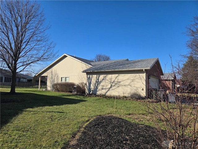 view of property exterior with a yard and a garage