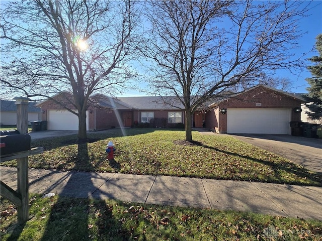 single story home with a garage and a front lawn