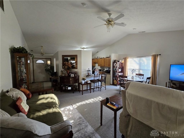 living room featuring ceiling fan, light colored carpet, and vaulted ceiling