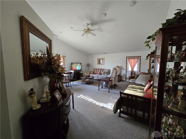 living room featuring carpet flooring, ceiling fan, and vaulted ceiling