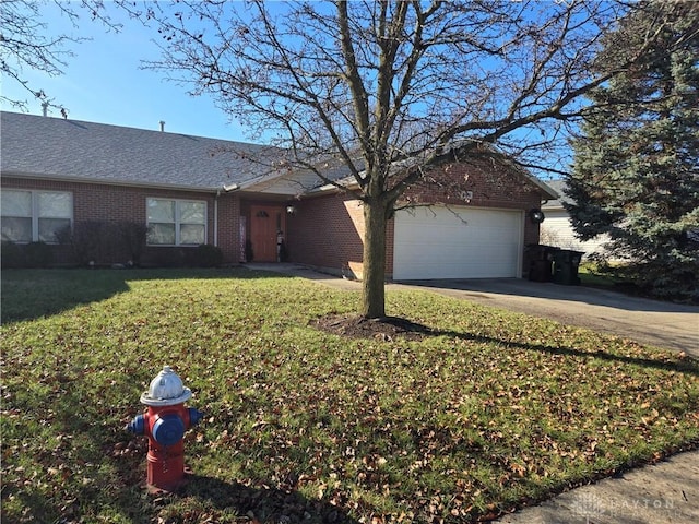 single story home featuring a garage and a front lawn