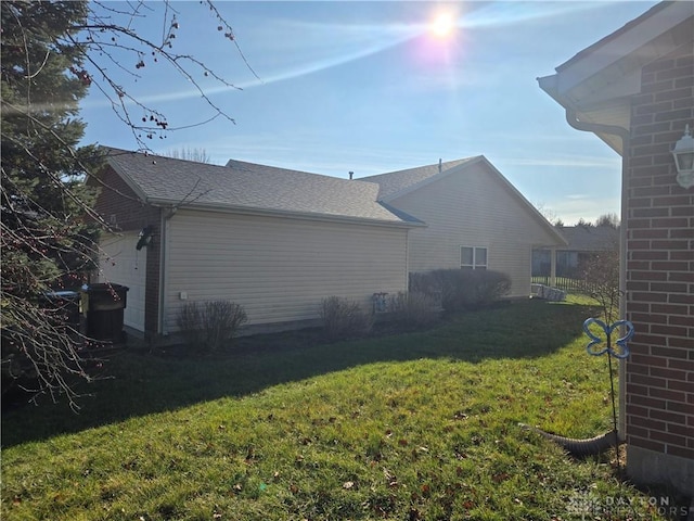 view of side of home with a lawn