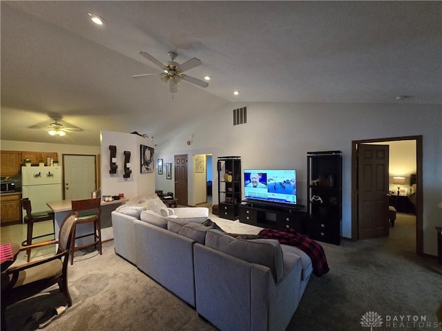 living room featuring carpet, ceiling fan, and vaulted ceiling