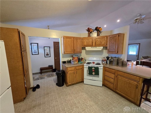 kitchen with ceiling fan, white appliances, and vaulted ceiling