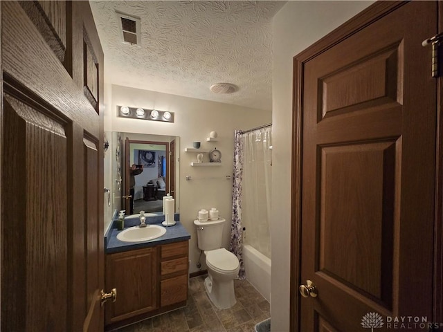 full bathroom with vanity, shower / tub combo, a textured ceiling, and toilet