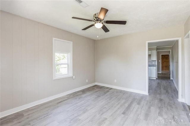 unfurnished room featuring ceiling fan and light hardwood / wood-style flooring