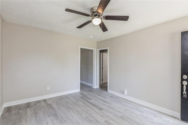 empty room featuring light wood-type flooring and ceiling fan