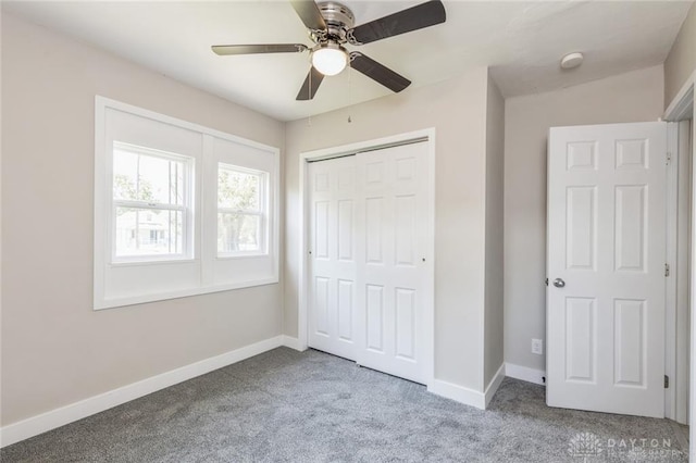 unfurnished bedroom with ceiling fan, carpet floors, and a closet