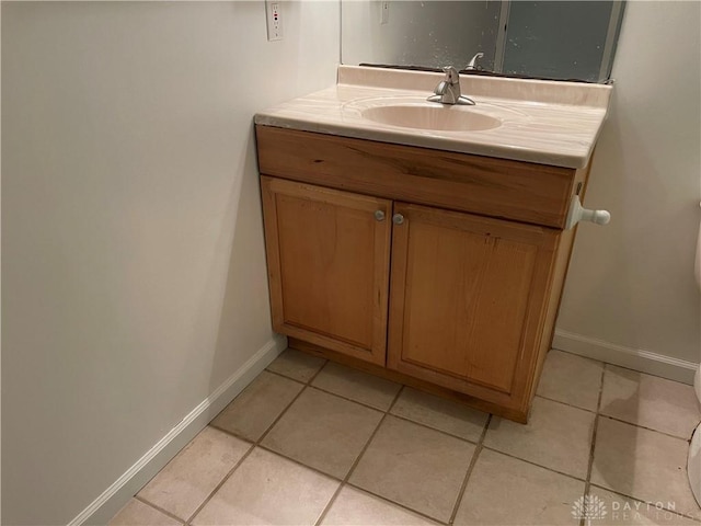 bathroom featuring tile patterned floors, vanity, and toilet