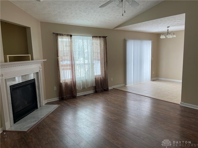 unfurnished living room with a fireplace, a textured ceiling, and hardwood / wood-style flooring