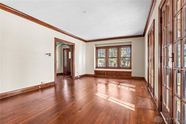 unfurnished room featuring crown molding and dark hardwood / wood-style floors