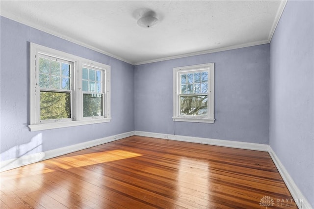 unfurnished room featuring hardwood / wood-style flooring and crown molding