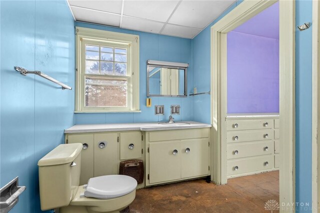 bathroom featuring vanity, a paneled ceiling, and toilet