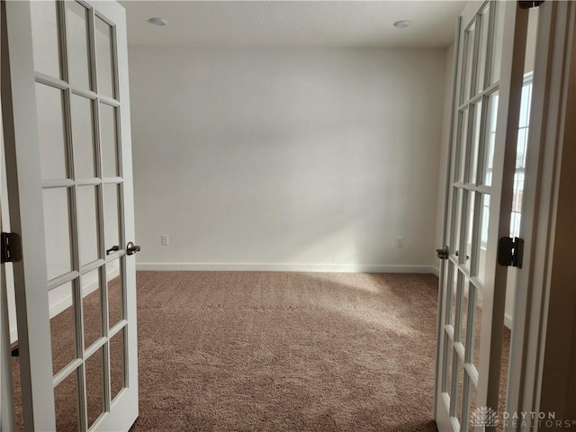 carpeted empty room with french doors